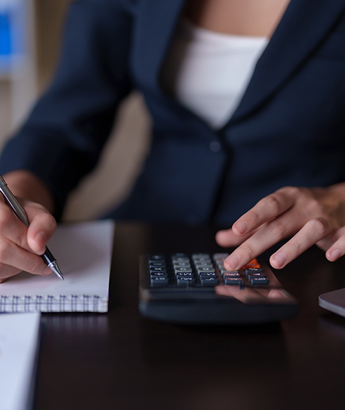 Close-up of the hands of a business woman using a calculator to check financial accounts check the company's expenses and budget.