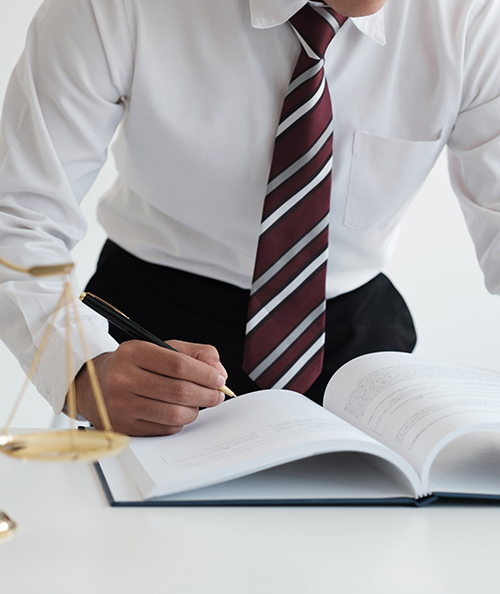 Lawyer sitting working at the desk hand holding pen for signing important documents. lawyer and law ,judiciary and legislature courtroom legal concept.