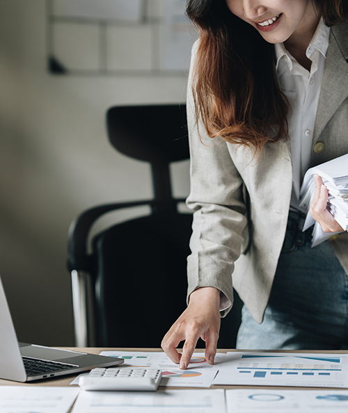 Businesswoman calculating bills, taxes and saving account balance. Finance concept.